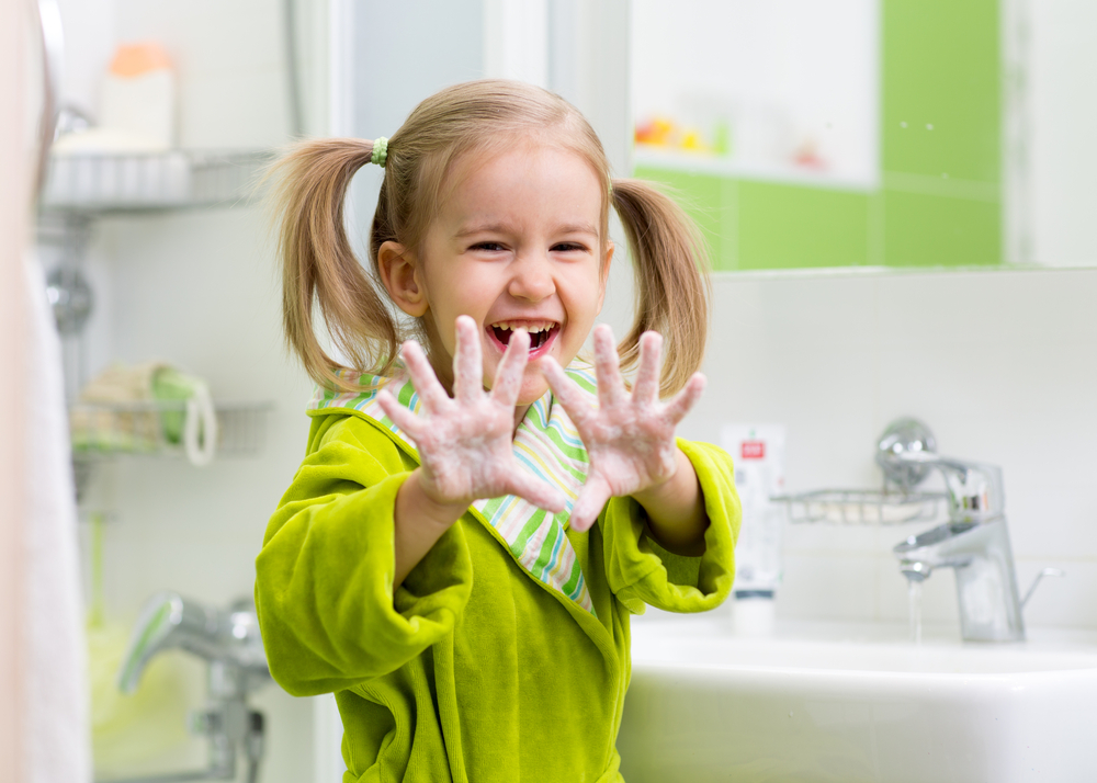 child washing hands