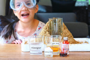 volcano eruption experiment with excited little girl