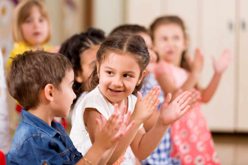 children clapping at school