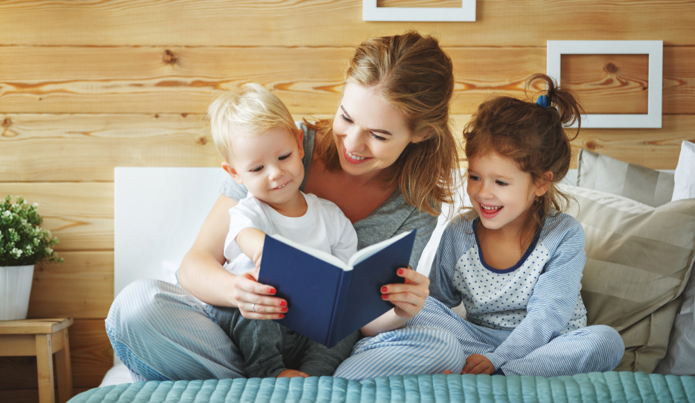 mom and two kids reading
