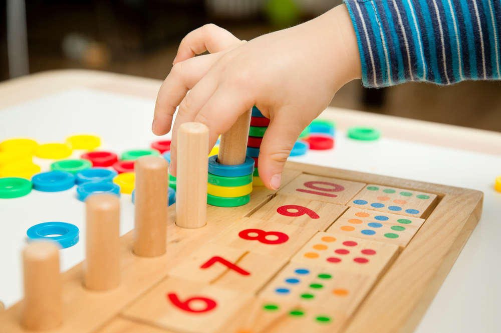 kid using toy to learn how to count