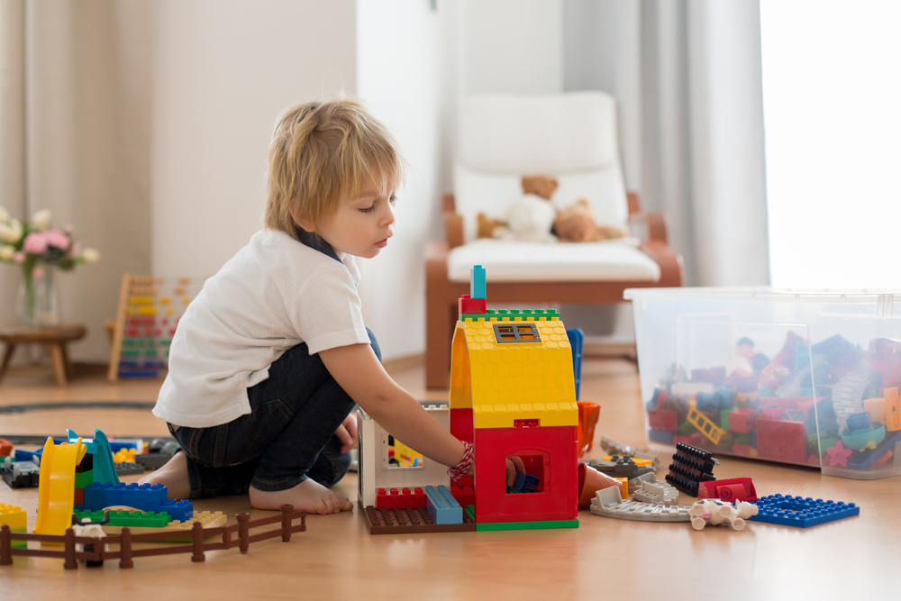 Toddler playing with barn toy 