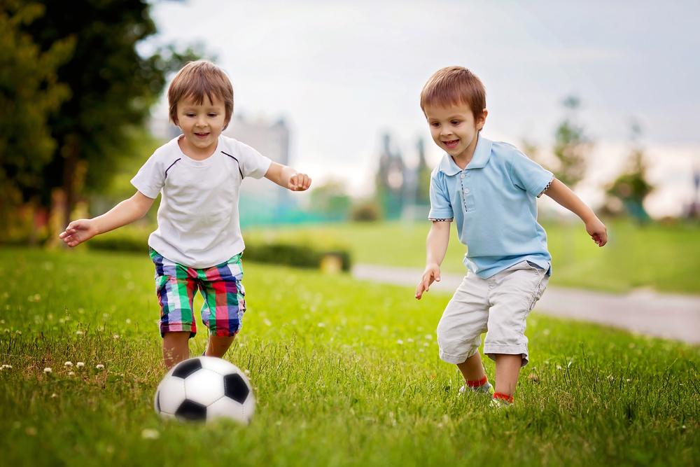 two little boys playing soccer